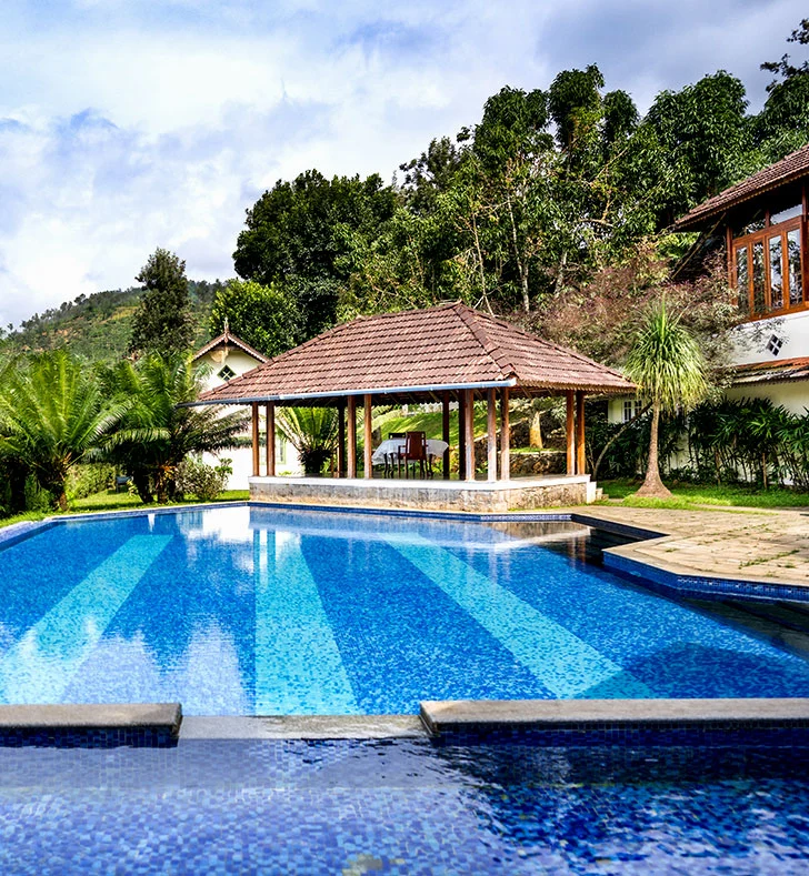 Heritage resort with swimming pool and gazebos in Thekkady